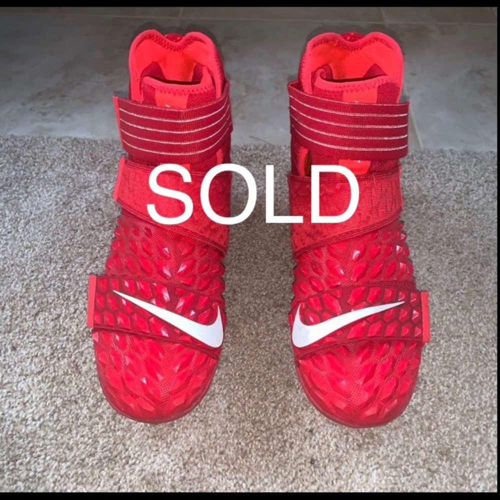 Men’s red/white NIKE football cleats size 10.
